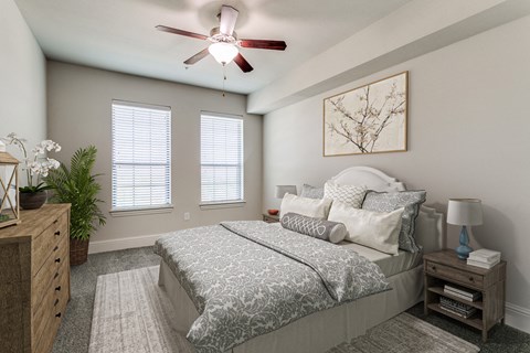 a bedroom with a bed and a ceiling fan