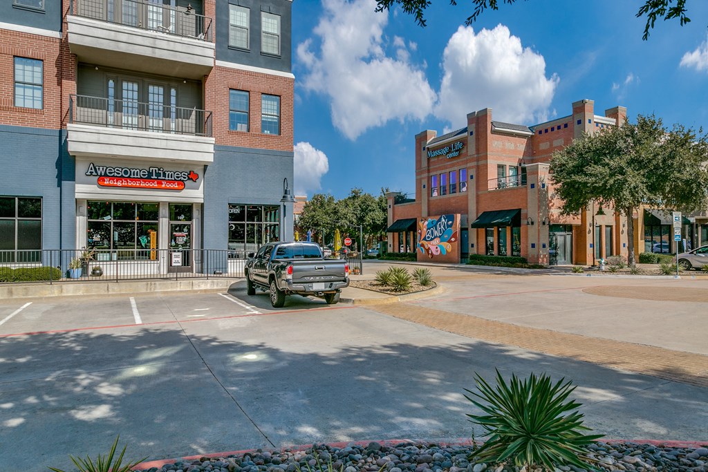 a truck parked in a parking lot in front of a building