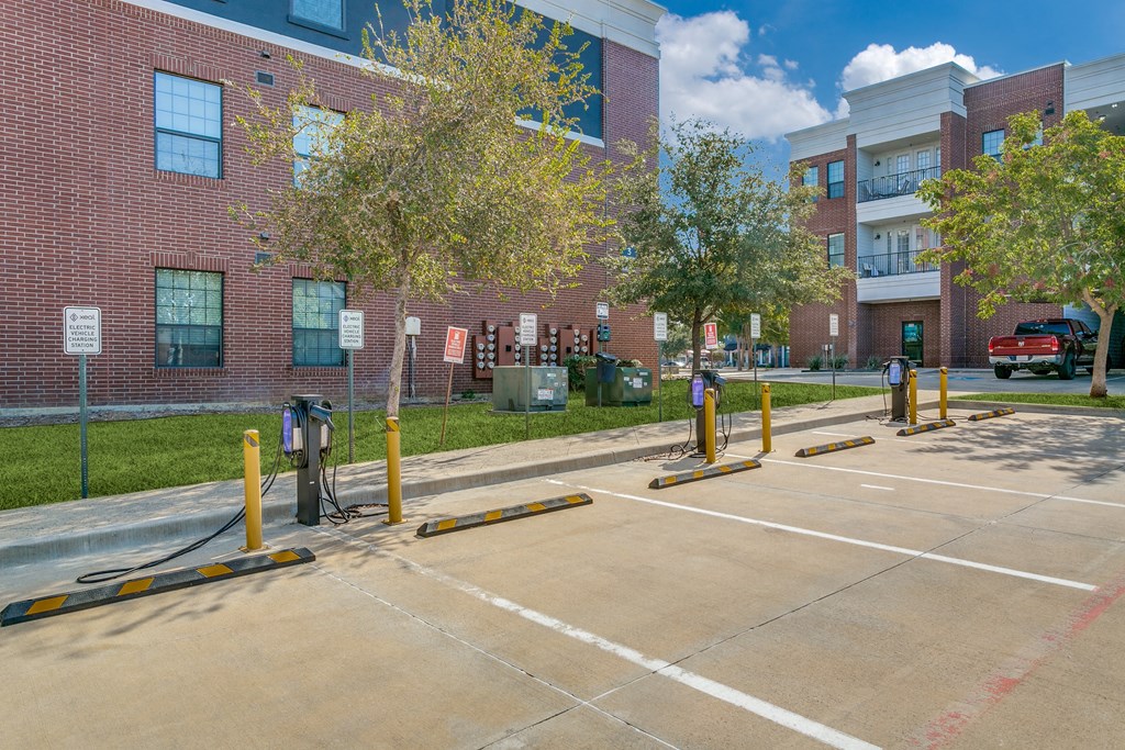 an empty parking lot in front of a brick building
