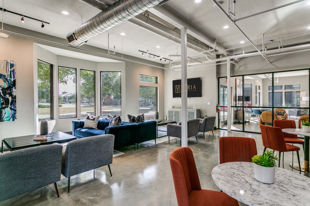 a lobby with couches and chairs and tables and chairs