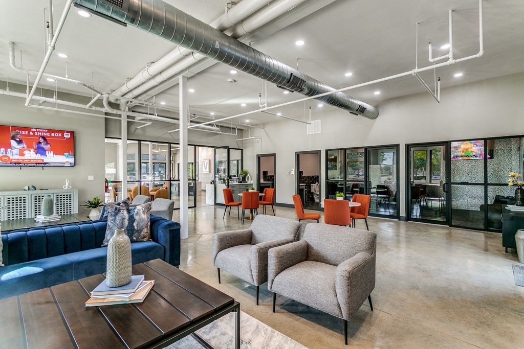 a living room with couches and chairs and a table