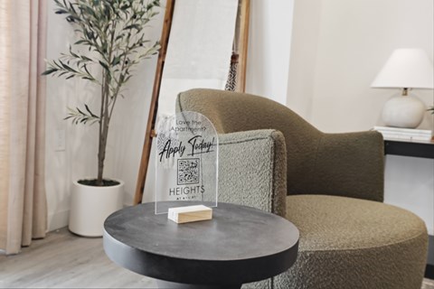 A chair with a sign that says "Happy New Year" is in front of a plant.