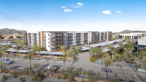 A large building complex with a parking lot in front.