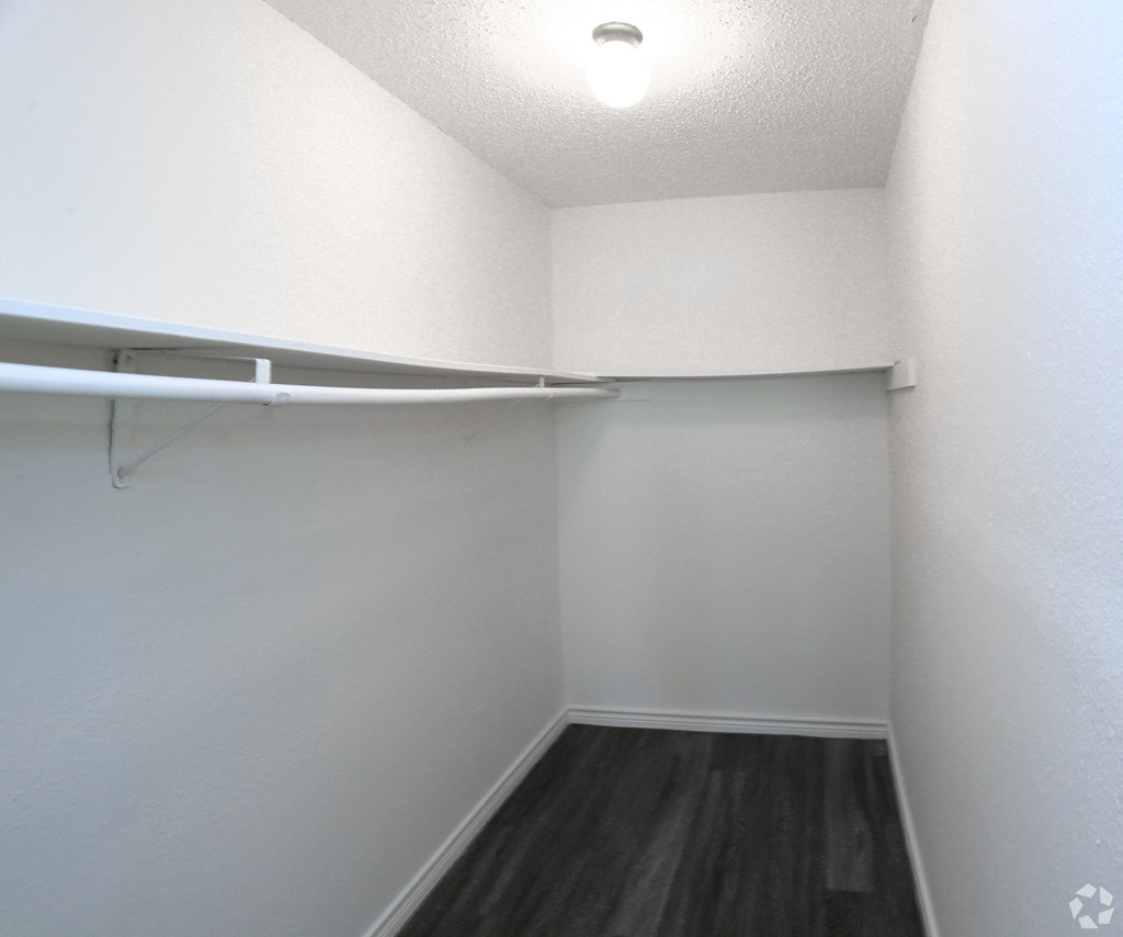 a walk in closet in a studio apartment
