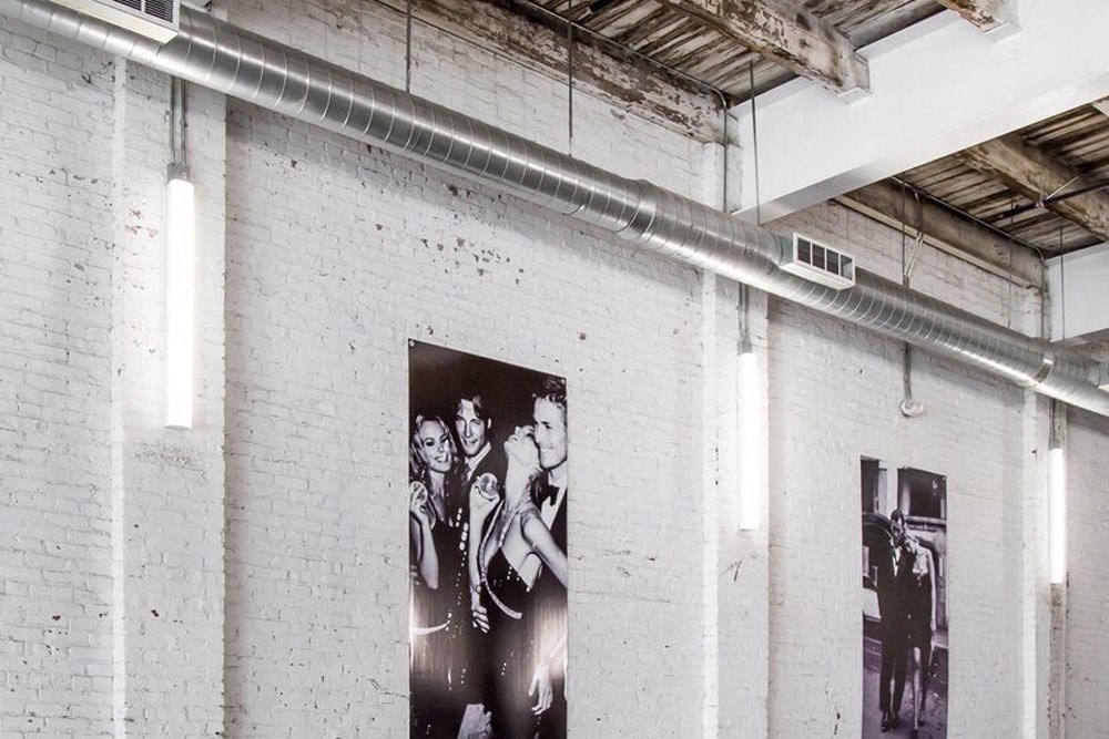 a black and white photo of the beatles on a brick wall