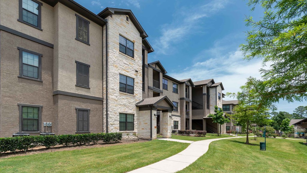 A building with a stone pillar and a white walkway in front.