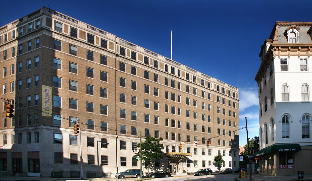 A large building with a lot of windows is in the foreground.
