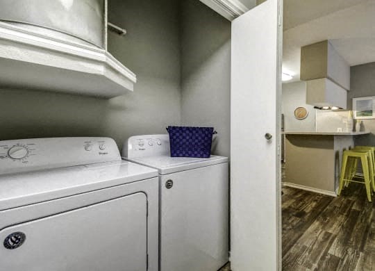 a white laundry room with a washer and dryer