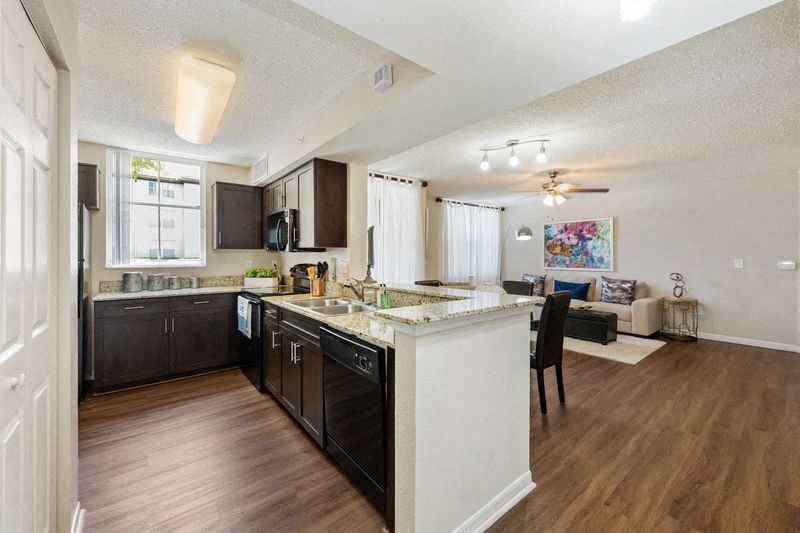 a kitchen and living room with an open floor plan