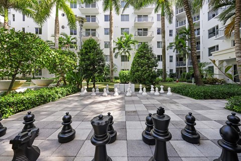 a game of chess in the courtyard of an apartment building