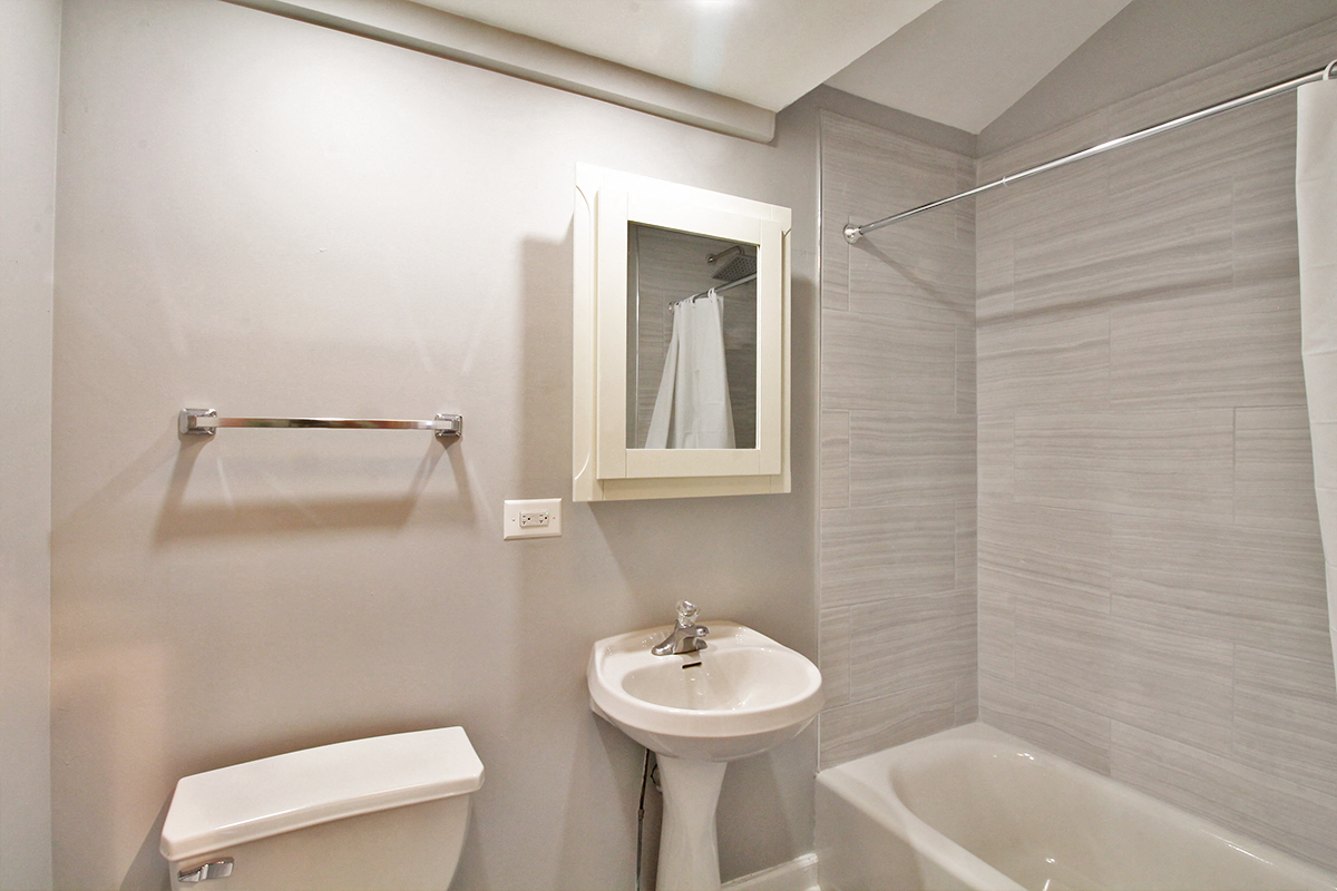A white toilet sits next to a sink in a bathroom.