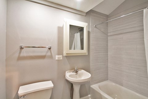 A white toilet sits next to a sink in a bathroom.