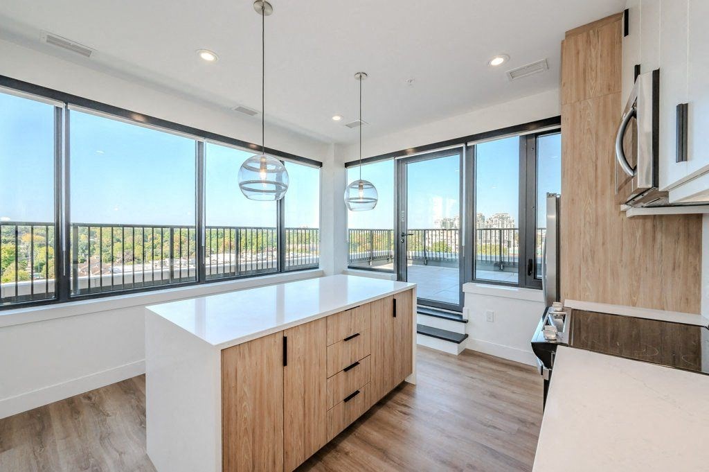a kitchen with a large window and a white counter top