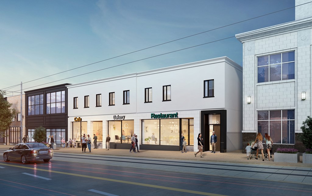 A street view of a building with a restaurant on the ground floor.