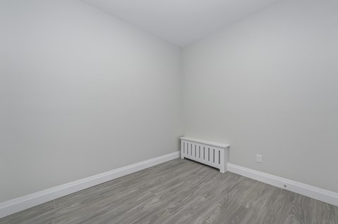 A room with a radiator on the wall.