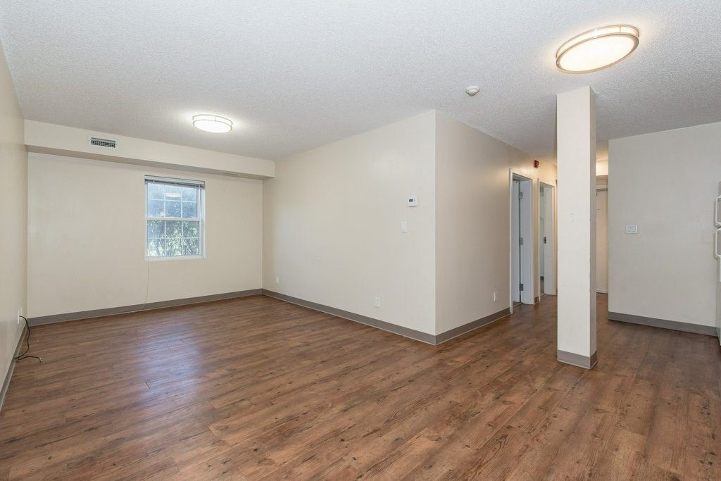 A room with wooden floors and white walls.