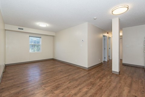 A room with wooden floors and white walls.