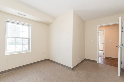 A room with a window and a door.