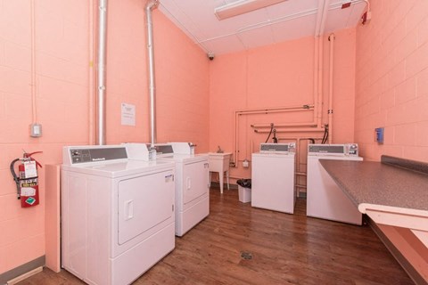 A laundry room with washers and dryers.