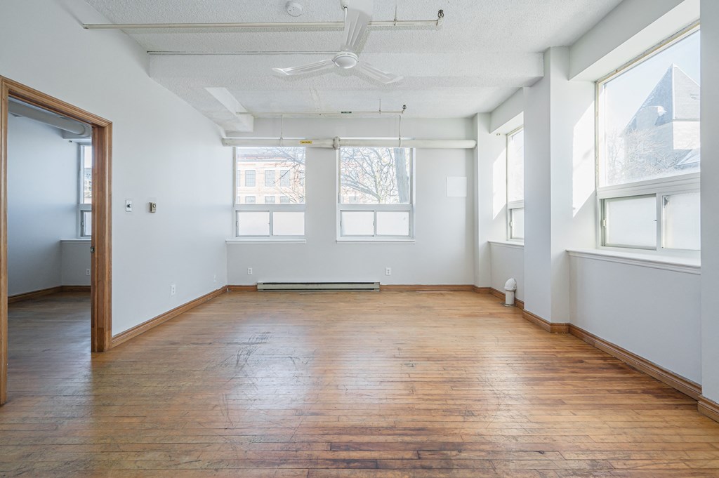 Empty room with wooden floor and white walls.