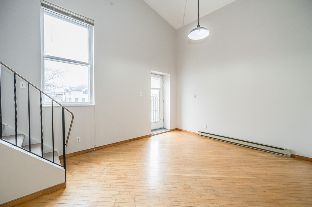 Empty room with wooden floor and white walls.