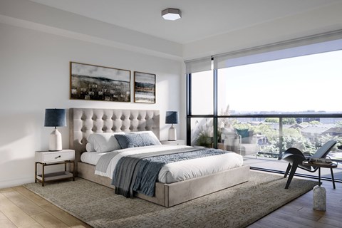 A bedroom with a large bed and a view of the city.