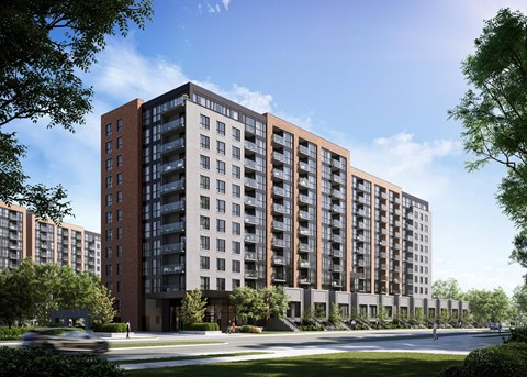 A large, modern apartment building with a brown and beige facade.