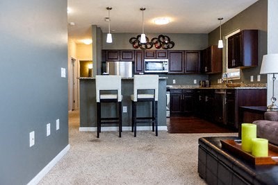 A kitchen with a refrigerator, oven, and microwave.