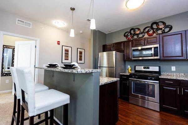 A kitchen with a white chair and a counter.