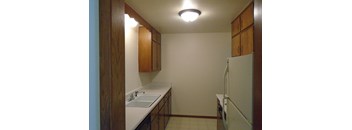 a kitchen with a sink and a refrigerator