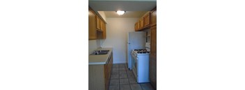 A kitchen with a white refrigerator and a white stove.