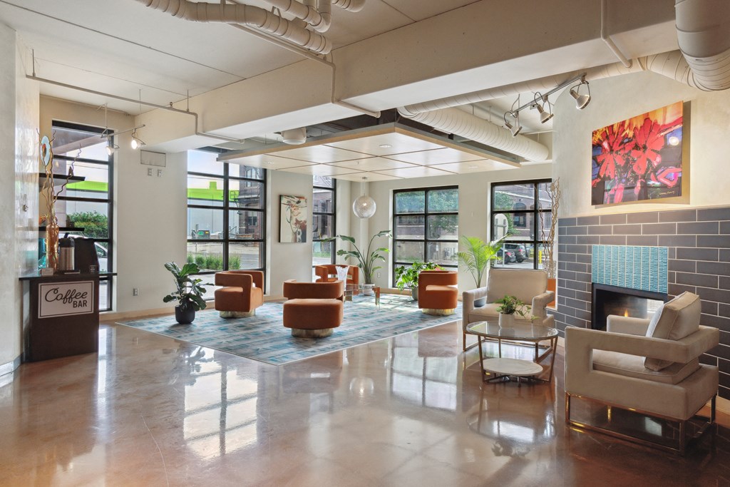 a large room with a fireplace and lots of chairs and couches