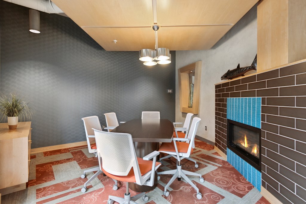 a room with a table and chairs and a fireplace