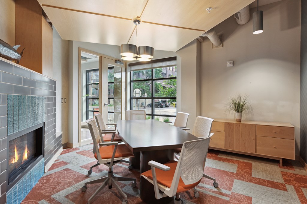 a room with a table and chairs and a fireplace