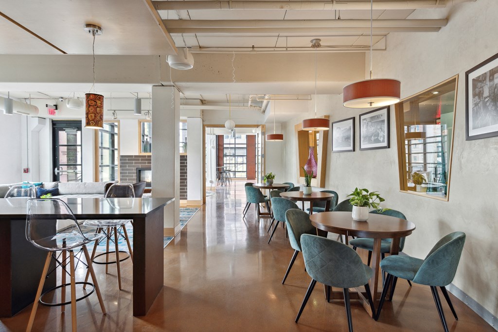 a dining area with tables and chairs and a bar