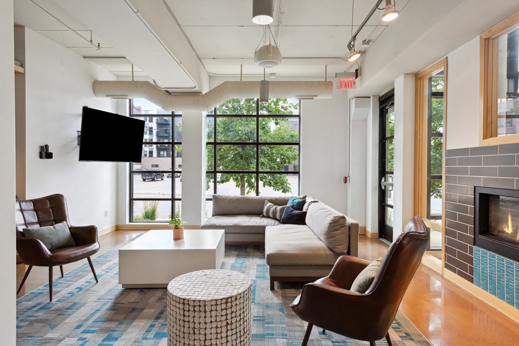 a living room with couches chairs and a fireplace