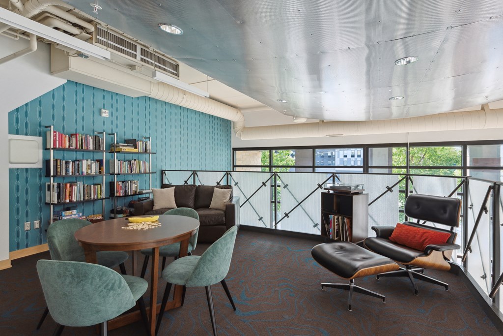 a living room with blue walls and a bookshelf