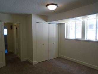 a bedroom with a closet and a window