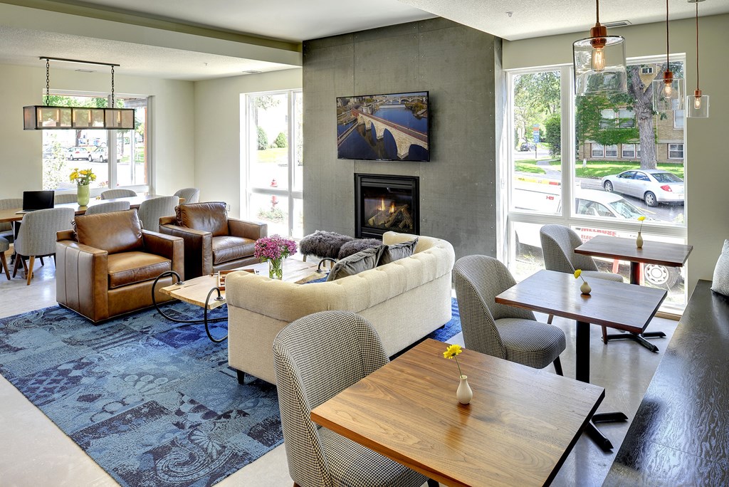 Coworking space with 3 tables, TV lounge and lobby area at Coze Flats