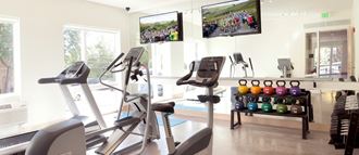 Coze Flats fitness center with a treadmill, elliptical, spin bike, free weights and kettle bells - Photo Gallery