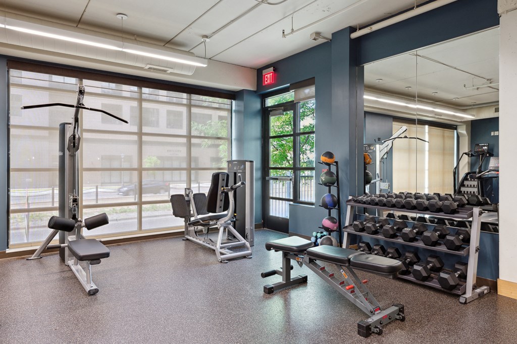 a workout room with weights and other exercise equipment