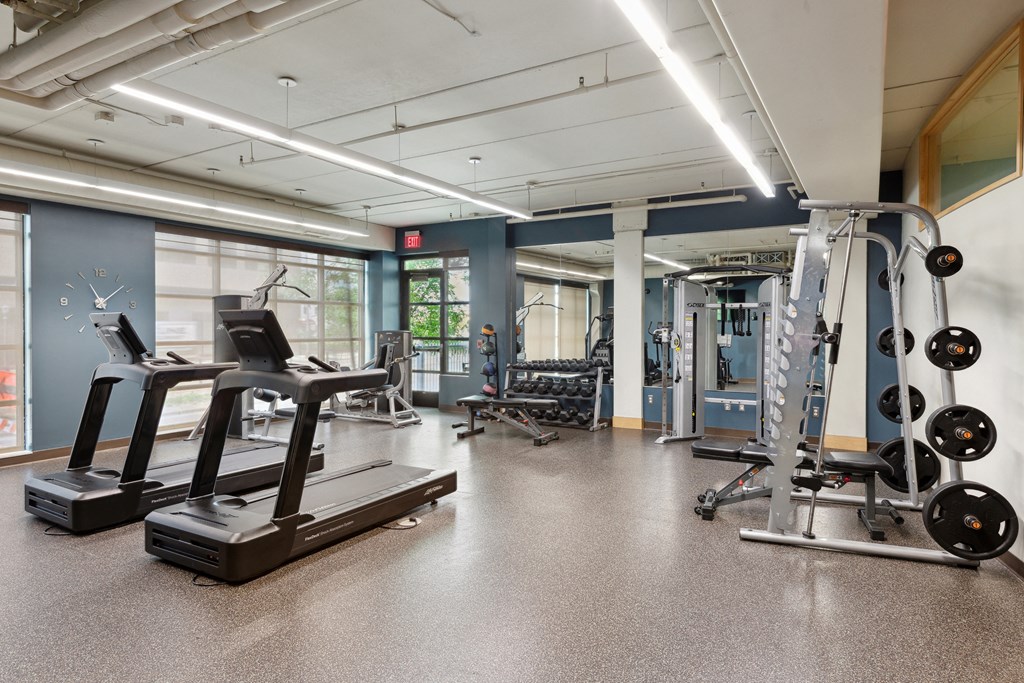 a spacious fitness center with treadmills and other exercise equipment