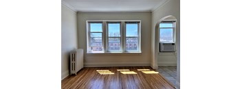 the living room of an empty house with sunlight coming through the windows