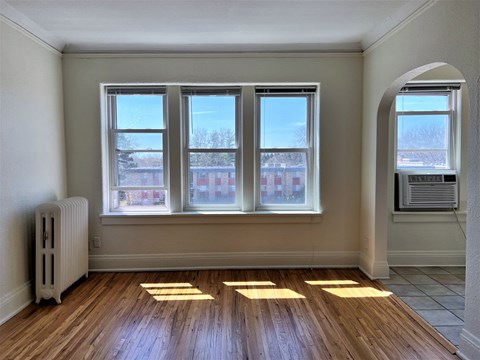 the living room of an empty house with sunlight coming through the windows