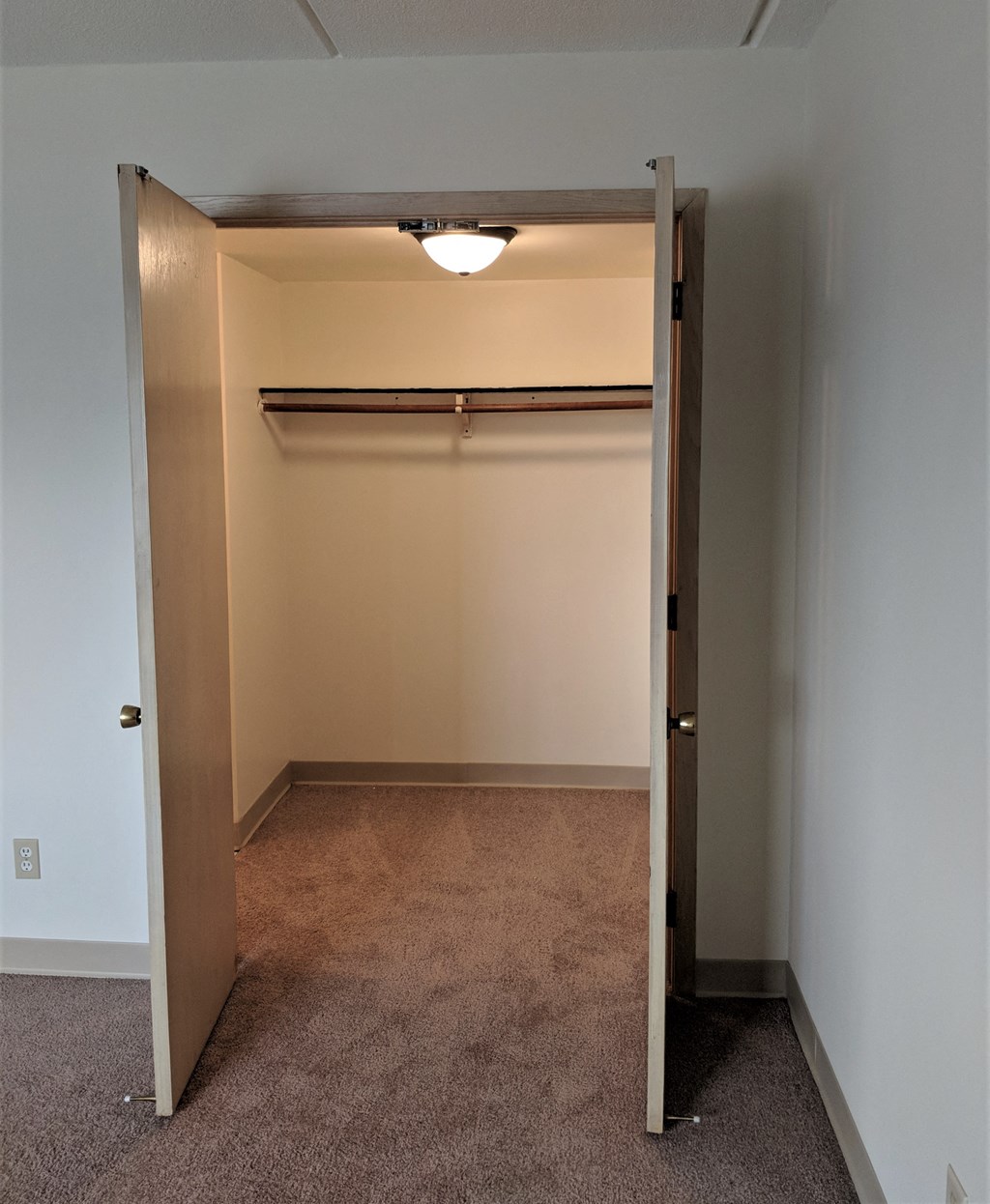 Photo of open closet with shelf at John Snell Apartments