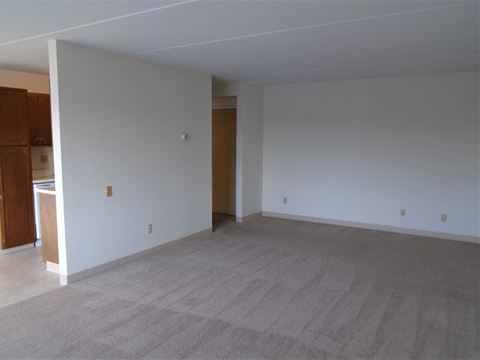 Living area with access to kitchen at John Snell Apartments