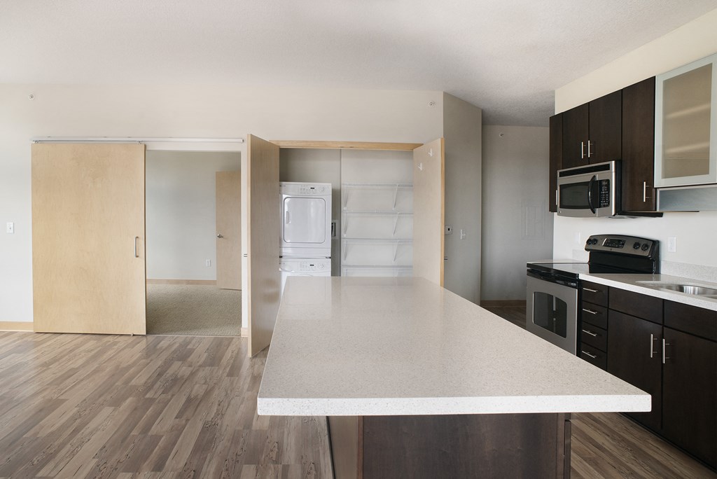an empty kitchen with an island in the middle