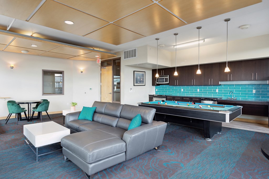 a games room with a pool table and couch