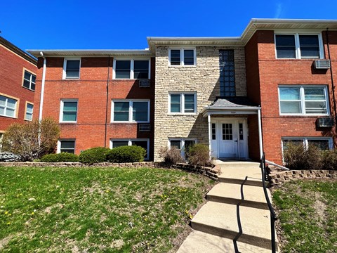 a brick apartment building with a blue sky in the background