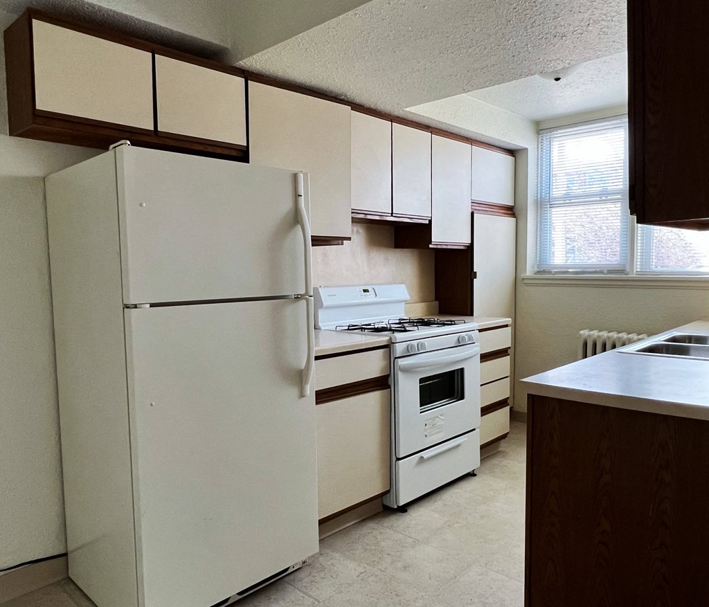 a kitchen with white appliances and white cabinets